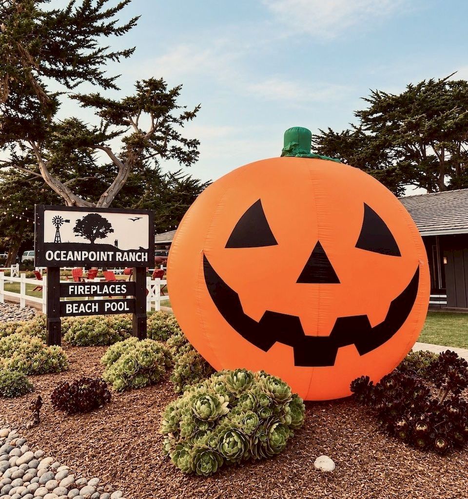 A giant inflatable jack-o&rsquo;-lantern sits in front of the &ldquo;Oceanpoint Ranch&rdquo; sign with pumpkins and succulents around it.